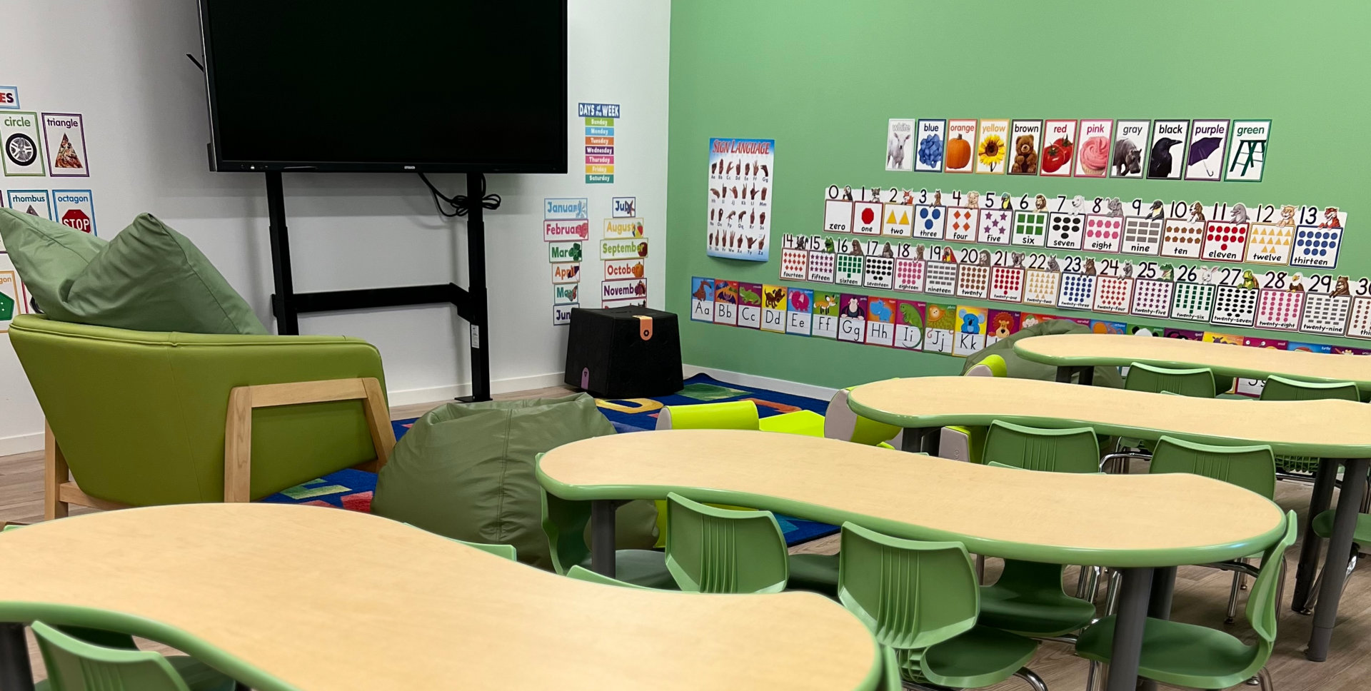 room with tables, chairs and a television