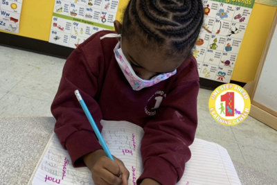 kid writting on his notebook